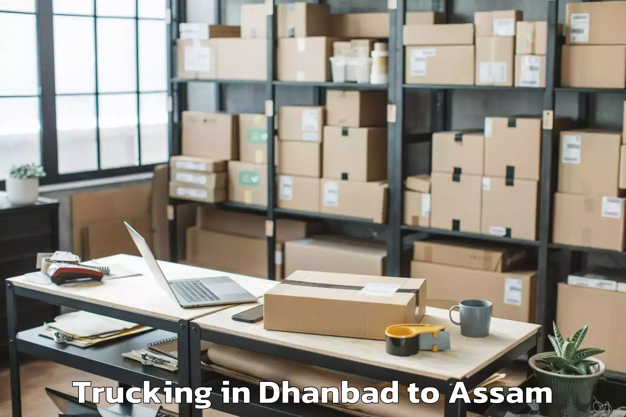 Book Dhanbad to Rupsi Airport Rup Trucking